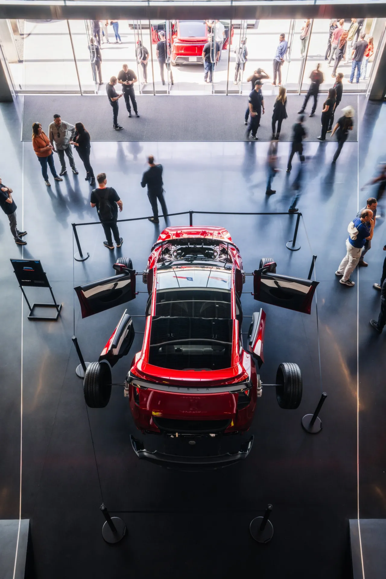 A red Tesla Model Y exhibit at a Tesla factory